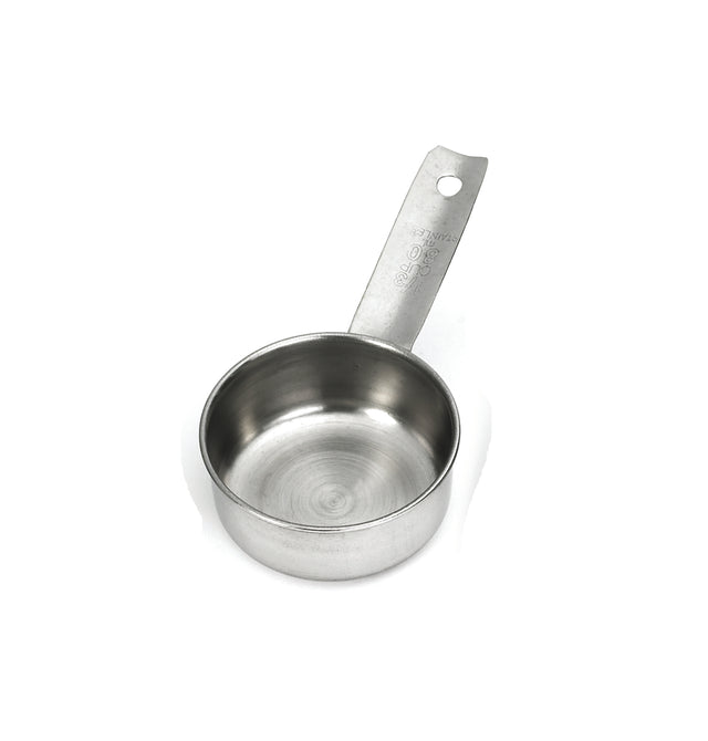 This stainless steel Measuring Cup features a flat bottom, straight sides, and a long handle with engraved measurement markings. Dishwasher safe, it has a hole for hanging and is shown empty on a white background.