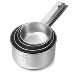 A set of four nested stainless steel measuring cups with engraved measurement markings, stacked together on a white background. The handles are aligned, feature holes for hanging, and the set is dishwasher safe for easy cleaning.