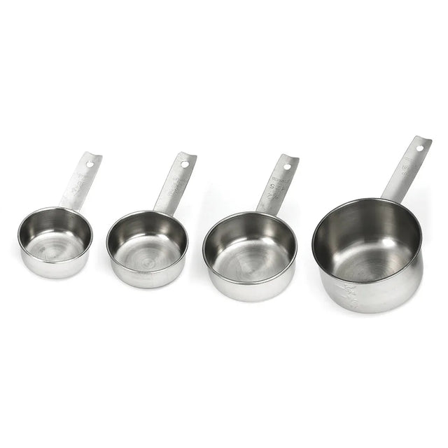Four stainless steel measuring cups of different sizes are arranged in a row from smallest to largest. Each dishwasher safe cup has a flat handle with a hole at the end, and engraved measurement markings, set against a white background.