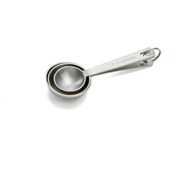 Three stainless steel measuring spoons, nested together and held by a metal ring. The top spoon is labeled 2 teaspoons. This dishwasher safe measuring spoon set has a sleek, shiny finish and is positioned on a white background with soft shadows.