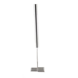 A stainless steel potato masher with a long cylindrical handle and a flat, grid-like mashing head made of parallel metal bars stands upright against a white background. The modern, minimalistic design is also dishwasher safe for easy cleaning.
