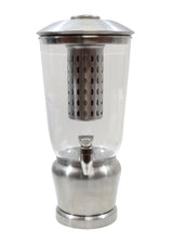 A BPA free beverage dispenser featuring a stainless steel and clear plastic body, cylindrical infuser, domed metal lid, spigot at the base, and a sturdy round metal stand for upright display.