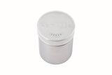 A stainless steel coffee shaker with a frosted plastic lid labeled Vanilla in raised letters. The lid also features a row of small holes for shaking out contents. Perfect for adding flavor to your gourmet coffee. Background is plain white.