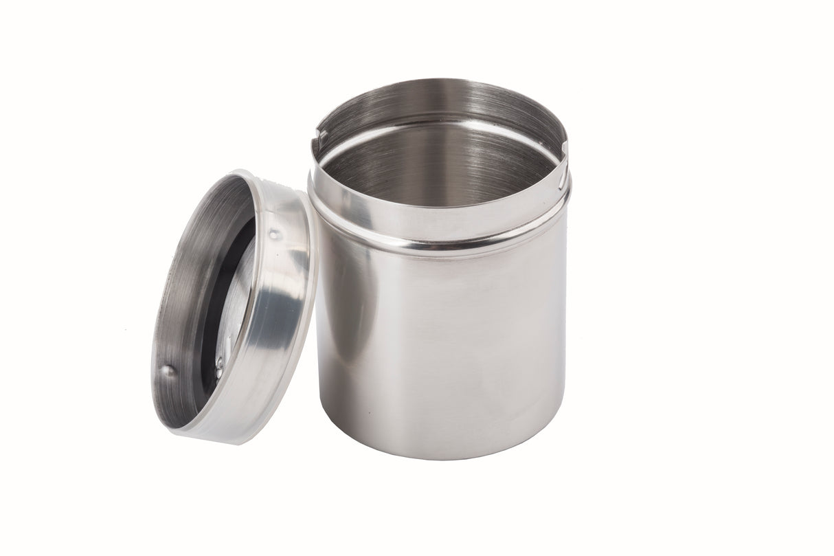 A stainless steel coffee shaker with a matching reflective lid rests beside it. The open, empty container is perfect for preparing gourmet coffee, displayed against a plain white background.