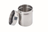 A stainless steel coffee shaker with a matching reflective lid rests beside it. The open, empty container is perfect for preparing gourmet coffee, displayed against a plain white background.
