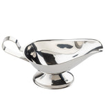 A shiny, reflective 18/8 stainless steel gravy boat with a wide spout, curved body, and sturdy pedestal base. Its smooth, rounded handle ensures easy pouring of sauces or gravies. Dishwasher safe. The background is plain white.