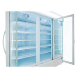 A large refrigerated merchandiser with glass swing doors stands open, revealing empty white wire shelves and bright interior lighting. The clean, modern design feels sterile, with visible fans at the top inside the commercial refrigerator.