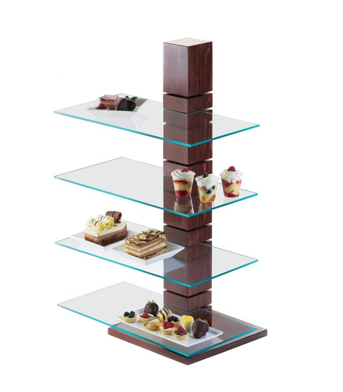 A modern Westport Pillar Riser dessert display stand with four staggered glass shelves attached to a central dark wood column, each shelf showcasing assorted parfaits, cakes, and pastries. The wide base matches the wooden column.