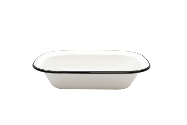 A rectangular white enamelware serving pan with slightly rounded corners and a black rim, photographed on a plain white background. Made from porcelain enamel coated steel, this dish is empty, glossy, and dishwasher safe.