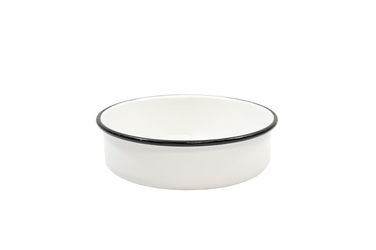 A small, round Enamelware Serving Bowl with straight sides and a thin black rim sits centered on a plain white background. Dishwasher safe, the bowl’s glossy finish gives it a clean and minimalist appearance.