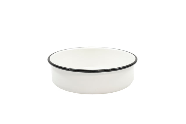 A small, round Enamelware Serving Bowl with straight sides and a thin black rim sits centered on a plain white background. Dishwasher safe, the bowl’s glossy finish gives it a clean and minimalist appearance.