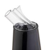 Close-up of a black, glossy PourMaster Complete Unit with two angled, transparent glass straws—both BPA free and dishwasher safe—inserted into its opening. The clean straws slightly overlap at the top against a plain white background.