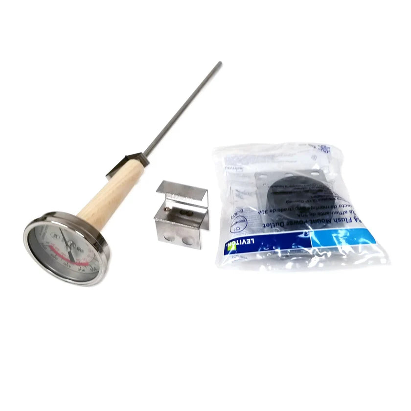 A dial thermometer with a metal probe and wooden handle is shown next to a small metallic clamp—ideal for use with a commercial fryer—and a sealed plastic bag containing a black circular item and blue-labeled card, all on a white background.