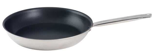 The Vulcano Fry Pan features an 18/10 stainless steel body with a stick resistant finish, a sleek black nonstick interior, and a long metal handle with a hanging hole. The gently sloped sides enhance its clean, unused look.