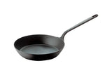 A black carbon steel fry pan with a smooth, round base and flared sides. It has a long, straight handle with a hole for hanging. Made of metal, this pan is suitable for induction cooking and is photographed on a white background.