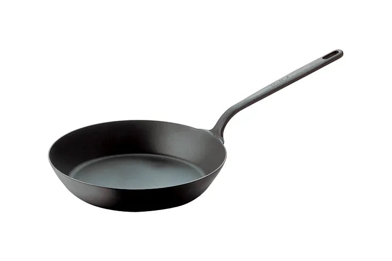 A black, round carbon steel fry pan with gently sloped sides and a long handle is shown on a white background. Ideal for induction cooking, the handle features a small hole at the end for hanging storage. The interior appears uncoated metal.