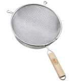 A tinned metal mesh strainer with a round bowl, two small support hooks on the rim, and a wooden handle featuring a hole at the end for hanging. The double fine mesh is tightly woven, ideal for straining liquids or sifting dry ingredients.