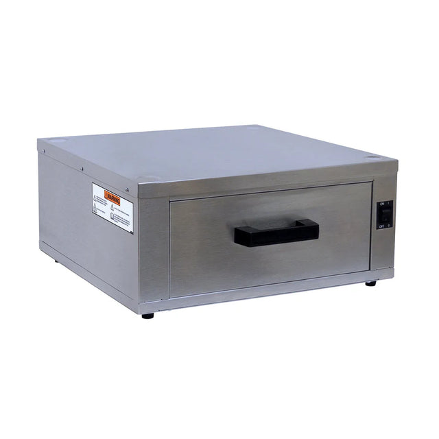 A Gold Medal Products stainless steel heated drawer bun cabinet features a black handle at the center, a rectangular front panel, small feet at the base, and a control switch on the right. Warning and instruction labels appear on the left side.