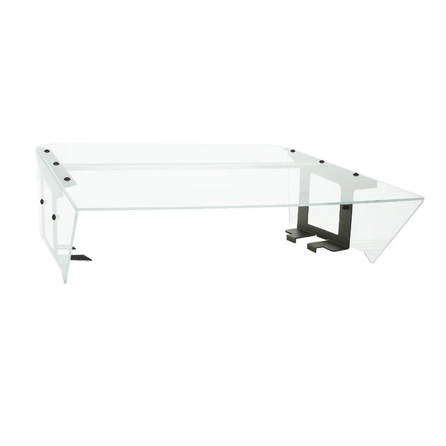A modern, transparent glass desk with a wide rectangular surface features a unique angular design, resembling the sleek lines of an NSF food shield. Black metal brackets and supports provide stability, creating an airy, minimalist appearance.