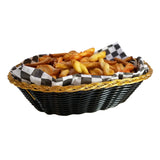 A hand-woven black basket with gold trim, lined with black-and-white checkered paper, filled with golden brown French fries of varying size and crispiness. The basket is isolated on a white background.
