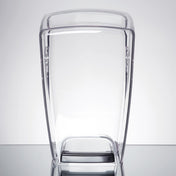 A clear, rectangular, plastic 64 oz. container with slightly curved sides and a black base stands upright on a reflective surface against a plain light gray background. The empty container has a smooth, minimalist design.
