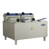 A commercial electric countertop fryer with stainless steel construction, two blue-lidded fry baskets, temperature control knobs, indicator lights, four sturdy legs, a “CaterRik” logo, and a yellow caution symbol on the front.