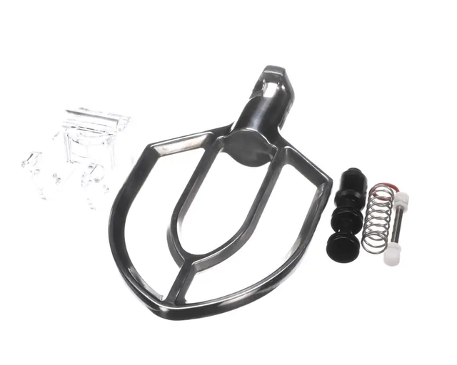 A metal Mixer Beater Attachment for the Admiral Craft PM-10, shaped like a flat paddle, lies beside various small parts including a clear plastic piece, two black cylinders, a spring, a pin, and a white cap on a plain white background.