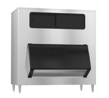 A commercial stainless steel ice machine with a large black front door, two black panels on the upper section, and four sturdy metal legs. Its modern, utilitarian design includes generous ice storage for efficient industrial or commercial use.