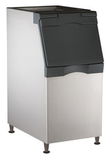 A large, NSF-certified stainless steel ice bin with a black, slanted, lift-up door and four short legs. Rectangular and smooth-surfaced, it's ideal for use with a top-mounted ice maker in restaurants or cafeterias to store and dispense ice.