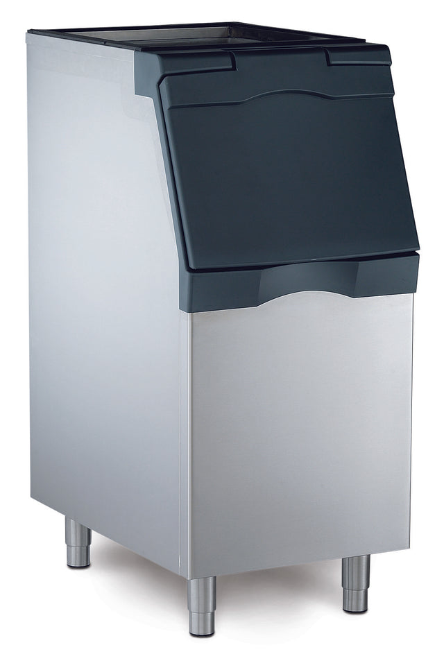 A stainless steel NSF ice bin with a black, slanted, flip-up lid stands on four metal legs. Its rectangular, sturdy design is ideal for commercial use in restaurants or bars and pairs perfectly with a top-mounted ice maker.