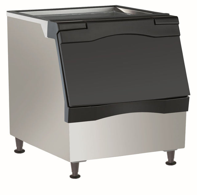 A commercial ice bin with a stainless steel body, black top lid, and black front access door. Polyurethane insulation ensures optimal ice storage, making it ideal for restaurants or food service setups using a top-mounted ice maker.
