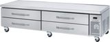 A stainless steel refrigerated chef base with four horizontal drawers, mounted on caster wheels. The right end features a vented panel and control display. The flat top surface serves as an ideal equipment stand for food prep in a professional kitchen.