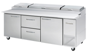 A large commercial stainless steel refrigerated prep table with three covered compartments on top, two drawers, and two doors below. This three-section Pizza Prep Table by True features vents for cooling and four caster wheels, set against a plain white background.