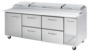 A large stainless steel Pizza Prep Table with four drawers, two compartment doors, and three-section covered top refrigerated storage. The unit is on wheels for mobility, featuring the True brand name on the right side.