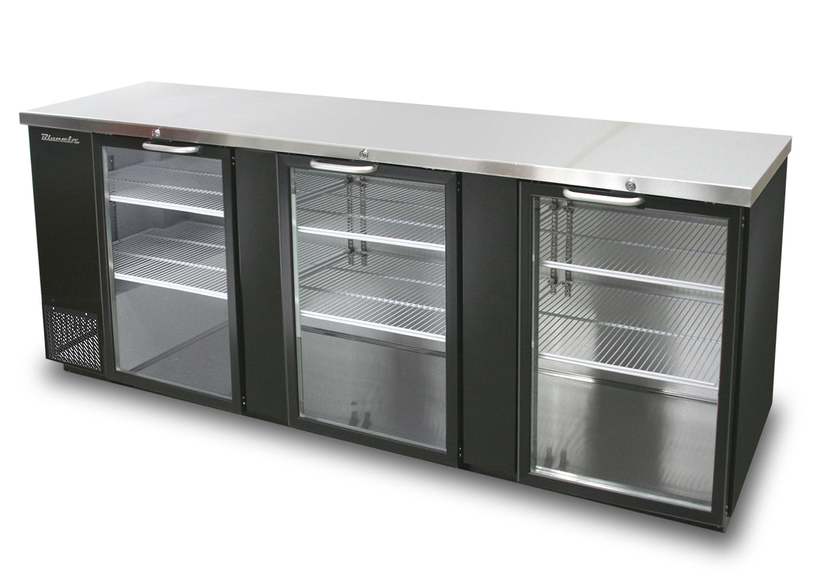 A sleek, modern three-section back bar cooler, featuring stainless steel and black accents. It has three glass hinged doors revealing empty metal wire shelves inside, a flat metallic countertop, and a cooling vent on the left side.