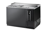 A sleek, industrial 50 inch bottle cooler featuring sliding stainless steel lids, a right-side vented refrigeration unit, and a built-in bottle opener with cap catcher. This commercial unit sits on short legs for easy cleaning underneath.