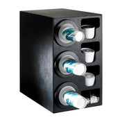 A black plastic NSF cup dispenser holds three stacks of blue and white paper cups horizontally on the left, with compartments for lids, small containers, and stir sticks on the right. The unit is angled to show both the front and side.