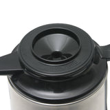 A close up of a glass vacuum insulated coffee pot, showcasing the sleek Brew-Thru Carafe design.