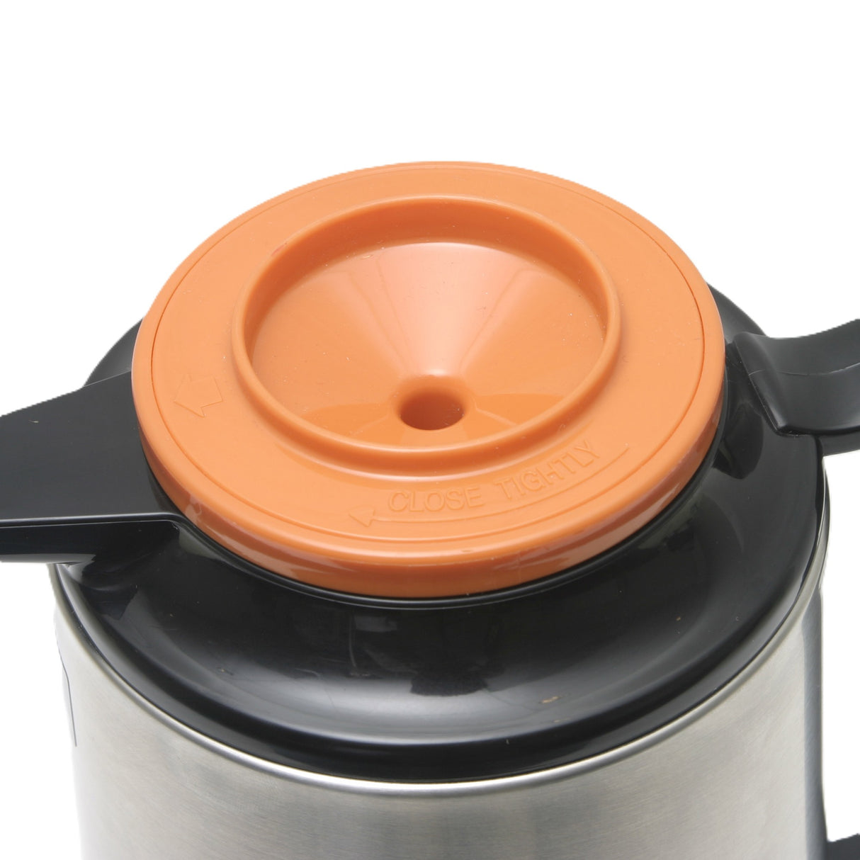 A close-up of a glass vacuum insulated metal thermos with a black handle and an orange plastic lid featuring a central hole and the words CLOSE TIGHTLY embossed along the rim. The Thermal Server lid also has arrows indicating the direction to close.