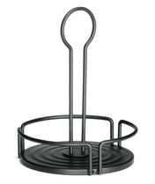 A black metal Versa Rack from TableCraft Products features a round base with three upright bars forming a partial circle. Its tall, looped handle ensures easy carrying—ideal as a minimalist shakers dispensers holder or for napkins and bottles.