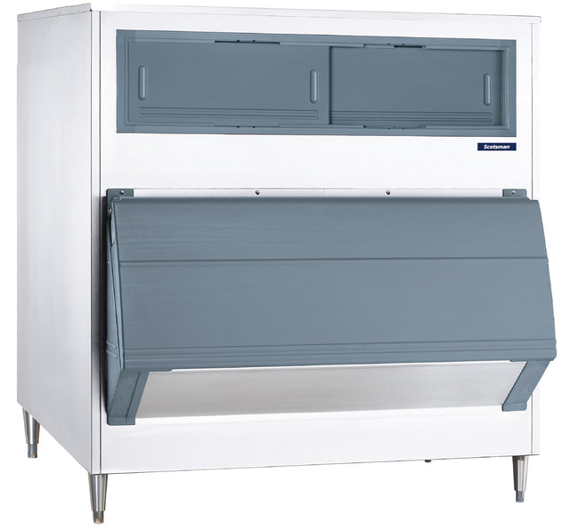 A large Upright Ice Storage Bin with a white exterior, gray double sliding doors on top, a slanted gray front bin door for ice access, and sturdy stainless steel legs. This unit has a 1000 lb capacity and features a small blue brand label on the upper right side.