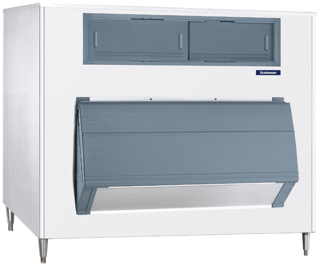 A commercial ice machine with a white exterior and gray front panel, featuring an upright ice storage bin. The unit stands on four metal legs and sports a small blue “Scotsman” label on the large angled door used for dispensing ice.