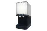A commercial stainless steel and black ice maker and water dispenser machine with dual spouts, control buttons, drip tray, and brand name “Manitowoc” on top; photographed against a plain light background.