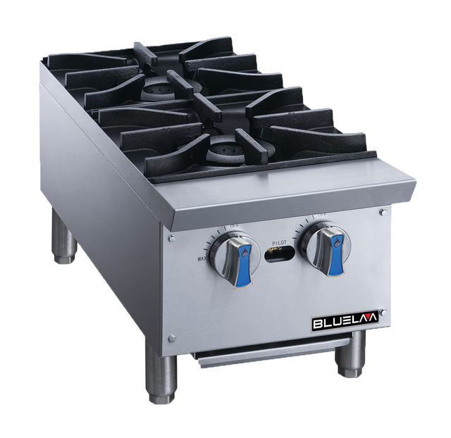 A heavy duty stainless steel countertop gas range with two black cast iron burners, blue-accented control knobs, sturdy legs, and the “Blueline” brand on front. The modern design resembles a professional hot plate and features a spotless surface.