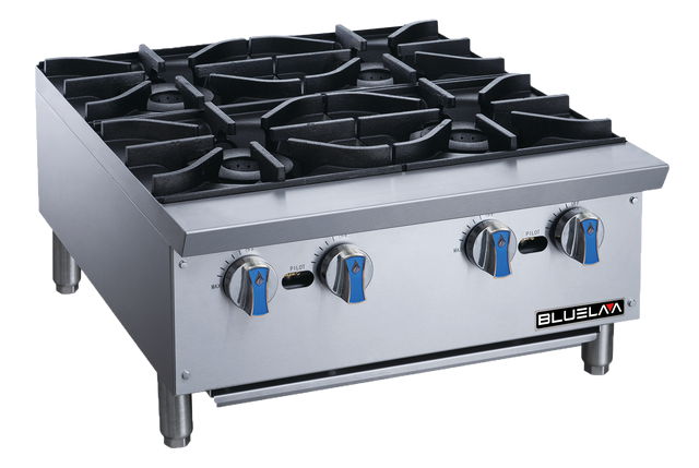 A stainless steel commercial gas stovetop with four burners, heavy cast iron grates, and blue-silver knobs rests on short metal legs. Ideal for countertop use, the clean “BLUELMA” unit stands against a plain background.