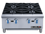 A stainless steel countertop commercial gas hot plate with four burners, each topped with a black cast iron grate. The control panel features four blue and silver knobs and is labeled BLUELAA on the bottom right. The background is plain white.