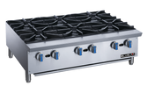 A stainless steel commercial gas stove with six large black cast-iron burners, six blue and black control knobs, and sturdy metal legs. This durable countertop unit features the brand name BLUELAVA on the right side of the front panel.