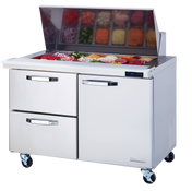 A stainless steel refrigerated prep table on wheels, with an open top displaying assorted sliced vegetables and toppings in bins. The unit features two drawers, a cabinet, and a digital temperature display on the front.