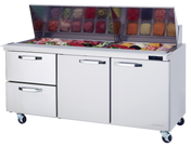 The Blue Air mega top sandwich prep table features casters, two drawers, two doors, and a top compartment for salad fixings like greens, tomatoes, and meats under a raised glass lid. A digital display shows the temperature for optimal freshness.