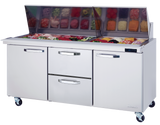 A commercial stainless steel sandwich prep table on wheels features a mega top glass section displaying chopped vegetables, with three closed compartments below: two side doors and a pull-out center drawer, perfect for efficient commercial refrigeration.